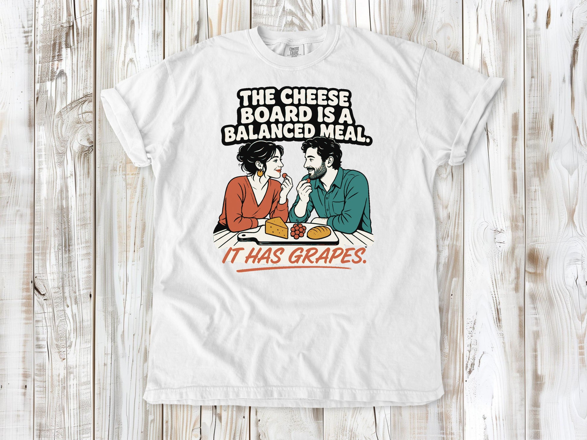 White garment-dyed tee with The Cheese Board Is a Balanced Meal It Has Grapes graphic.
