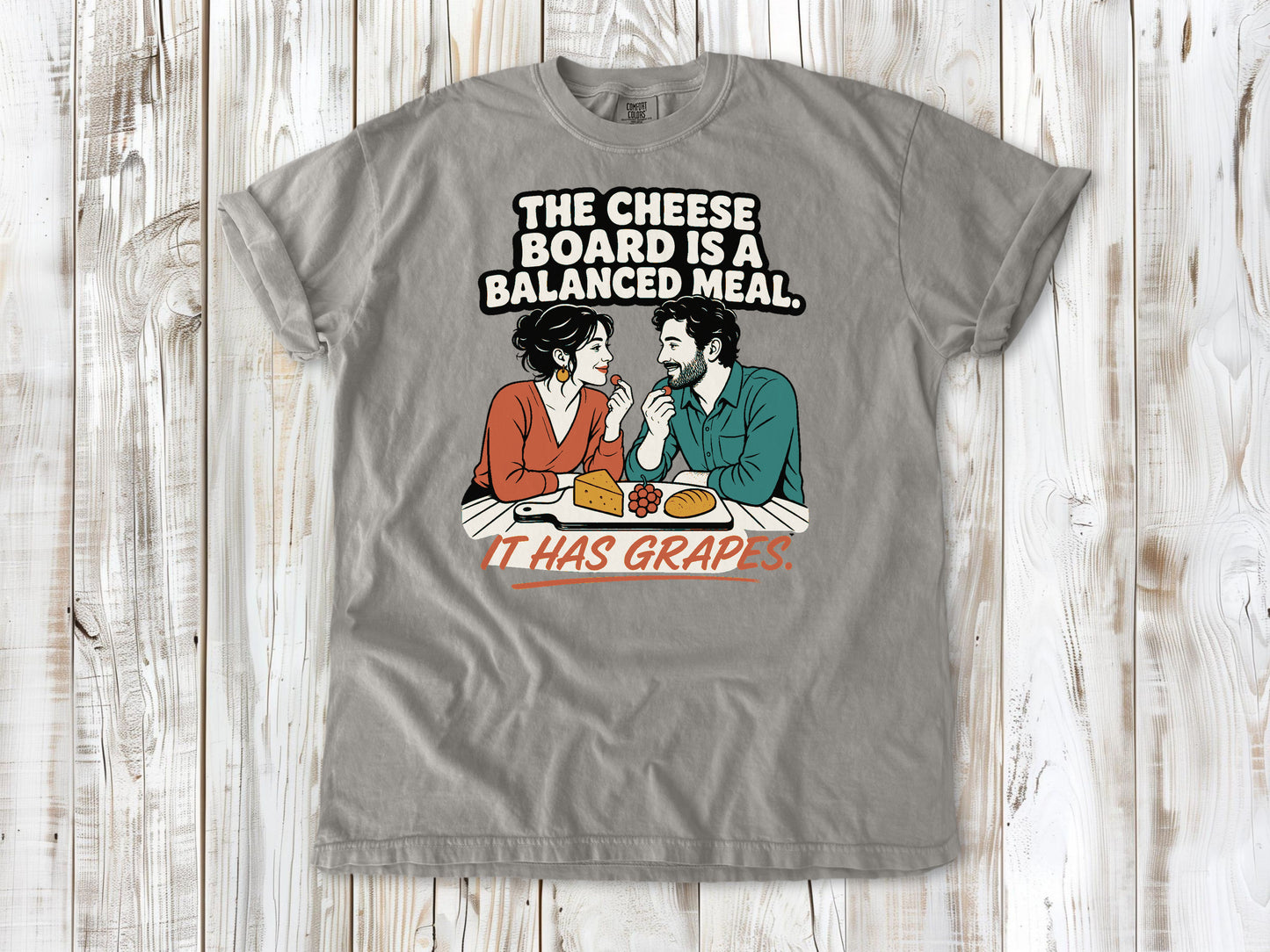 Khaki garment-dyed tee with The Cheese Board Is a Balanced Meal It Has Grapes graphic.