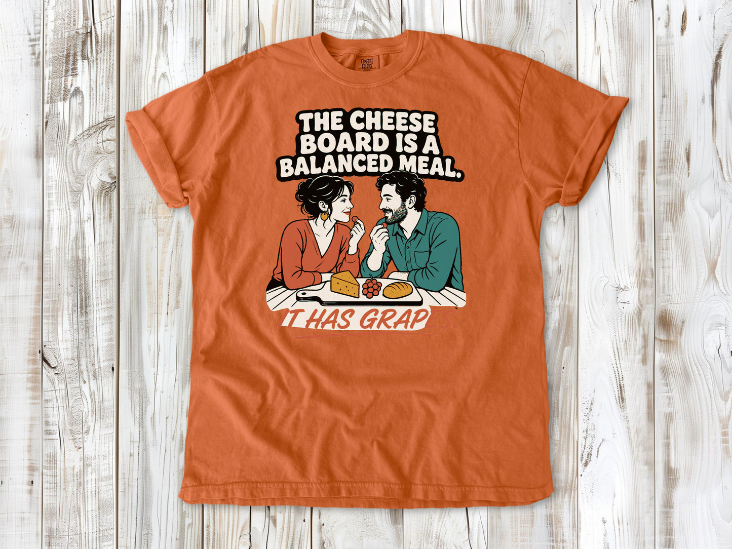 Seafoam garment-dyed tee with The Cheese Board Is a Balanced Meal It Has Grapes graphic.