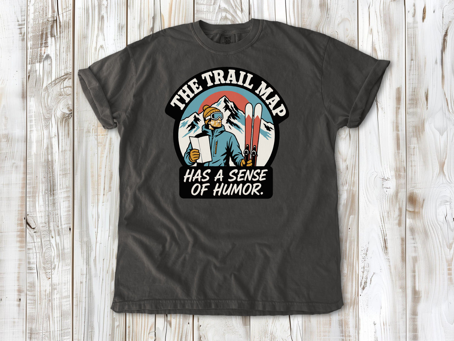 Ivory garment-dyed tee with The Trail Map Has a Sense of Humor hiking graphic.
