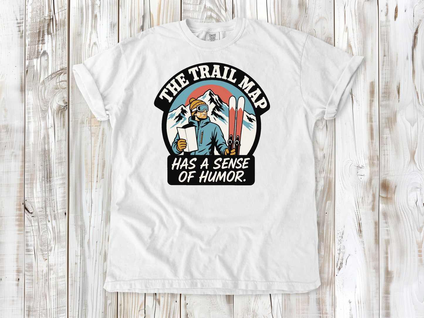 White garment-dyed tee with The Trail Map Has a Sense of Humor hiking graphic.