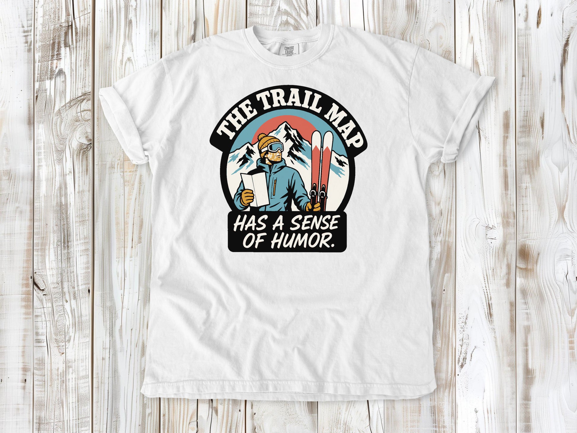 White garment-dyed tee with The Trail Map Has a Sense of Humor hiking graphic.