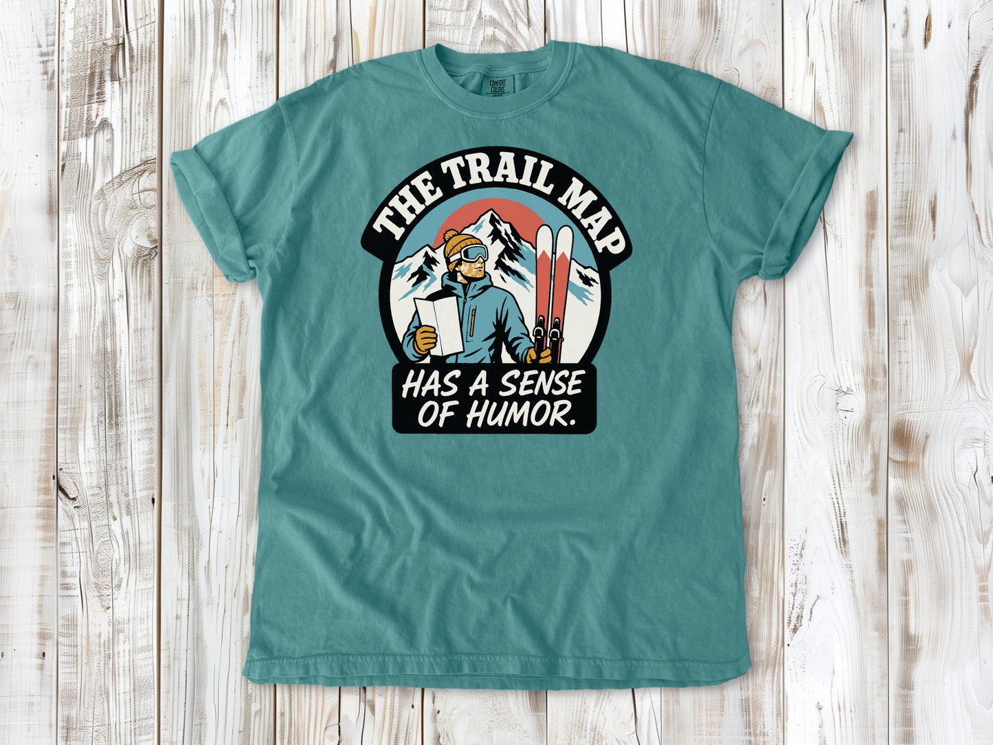 Mustard garment-dyed tee with The Trail Map Has a Sense of Humor hiking graphic.