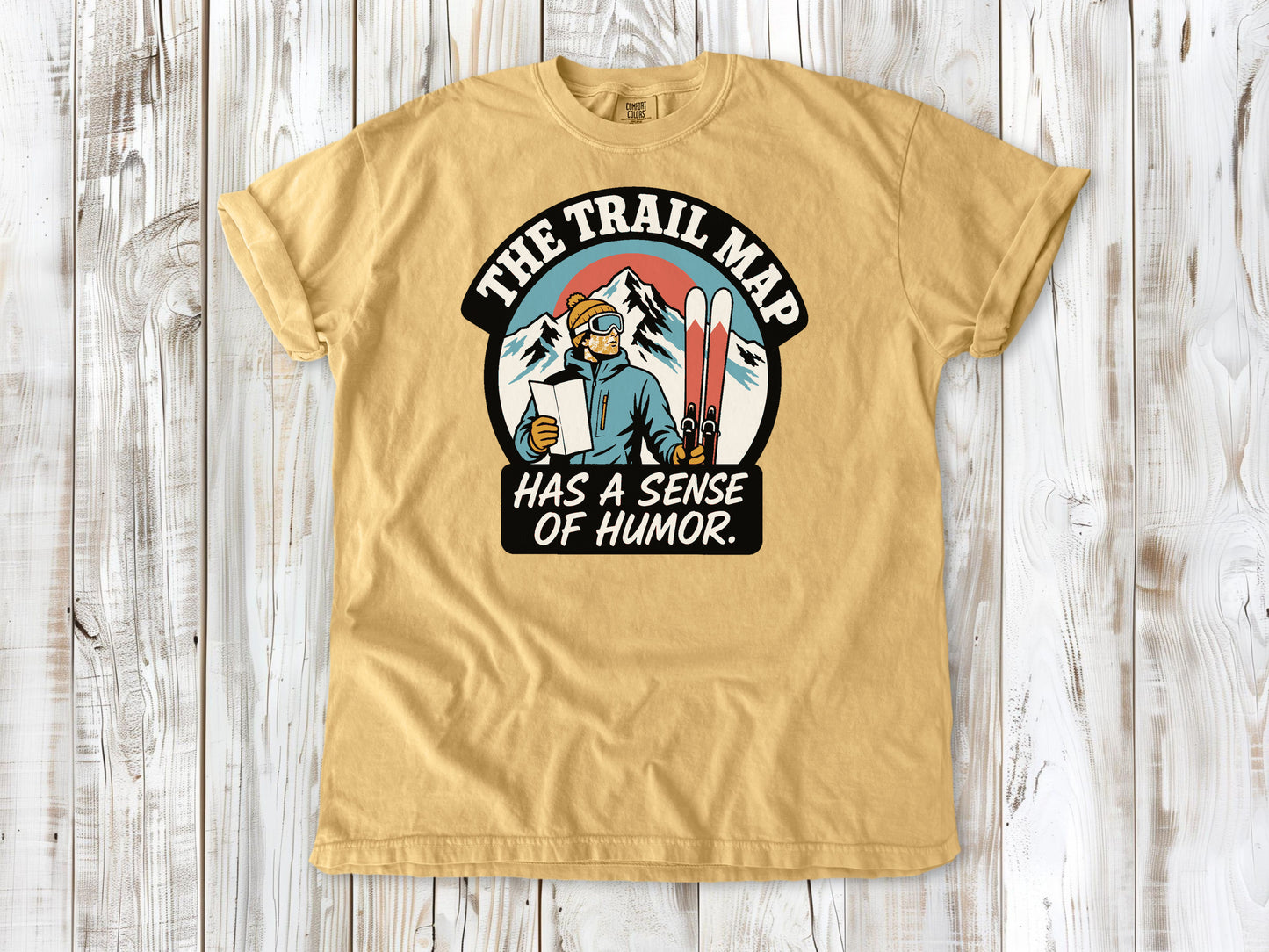 Burnt Orange garment-dyed tee with The Trail Map Has a Sense of Humor hiking graphic.