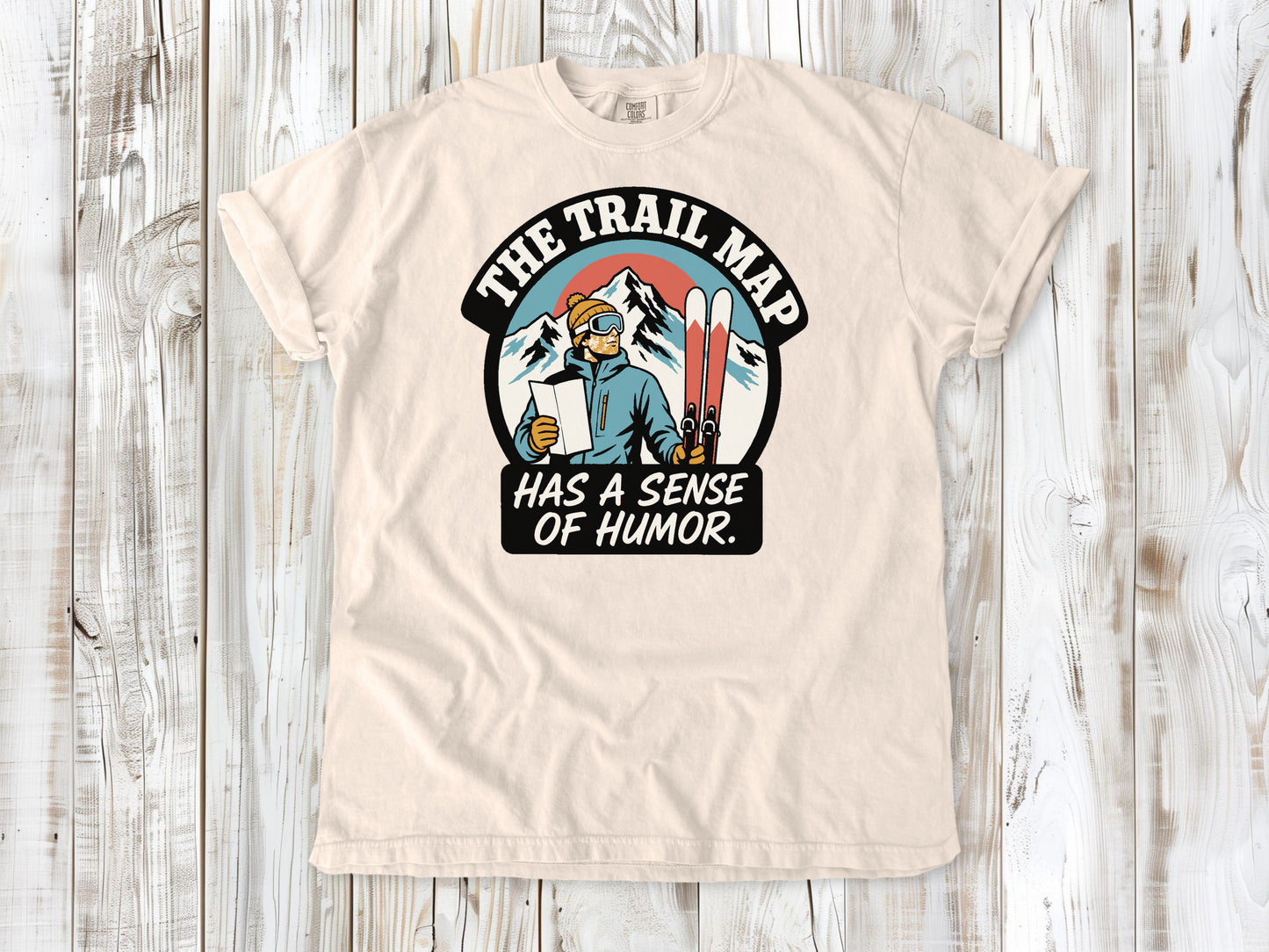 Butter garment-dyed tee with The Trail Map Has a Sense of Humor hiking graphic.