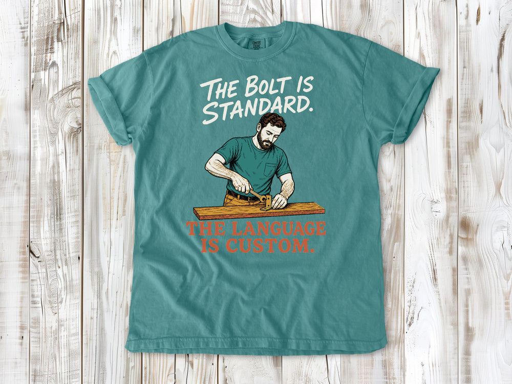 Mustard garment-dyed tee with The Bolt Is Standard The Language Is Custom mechanic graphic.