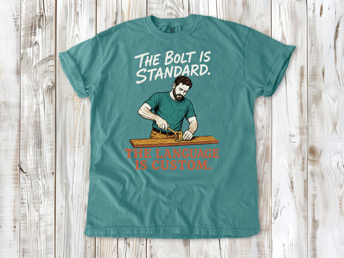 Mustard garment-dyed tee with The Bolt Is Standard The Language Is Custom mechanic graphic.