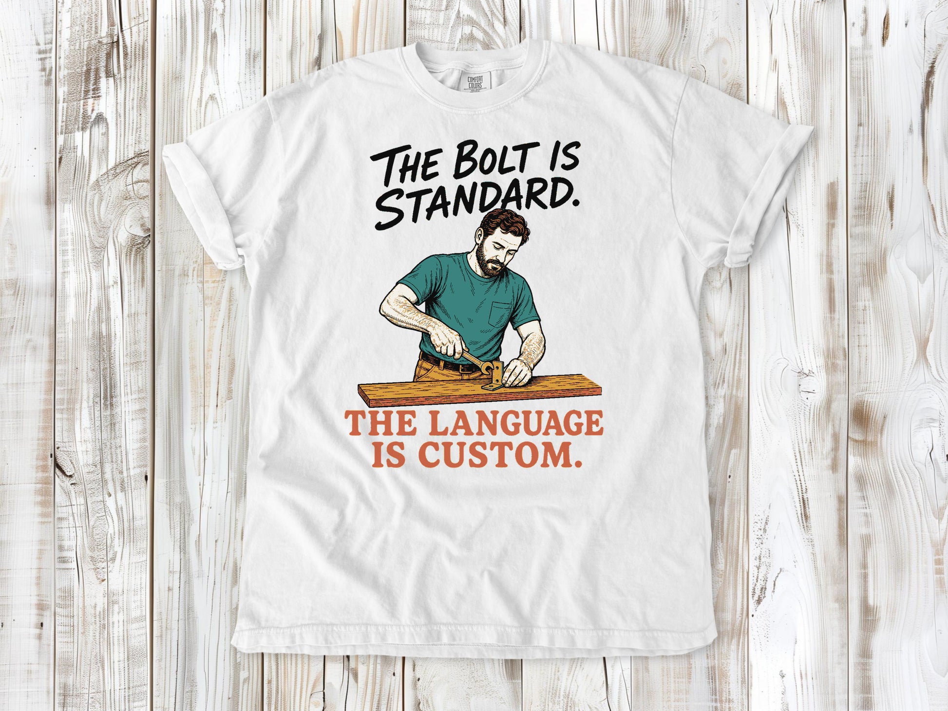White garment-dyed tee with The Bolt Is Standard The Language Is Custom mechanic graphic.