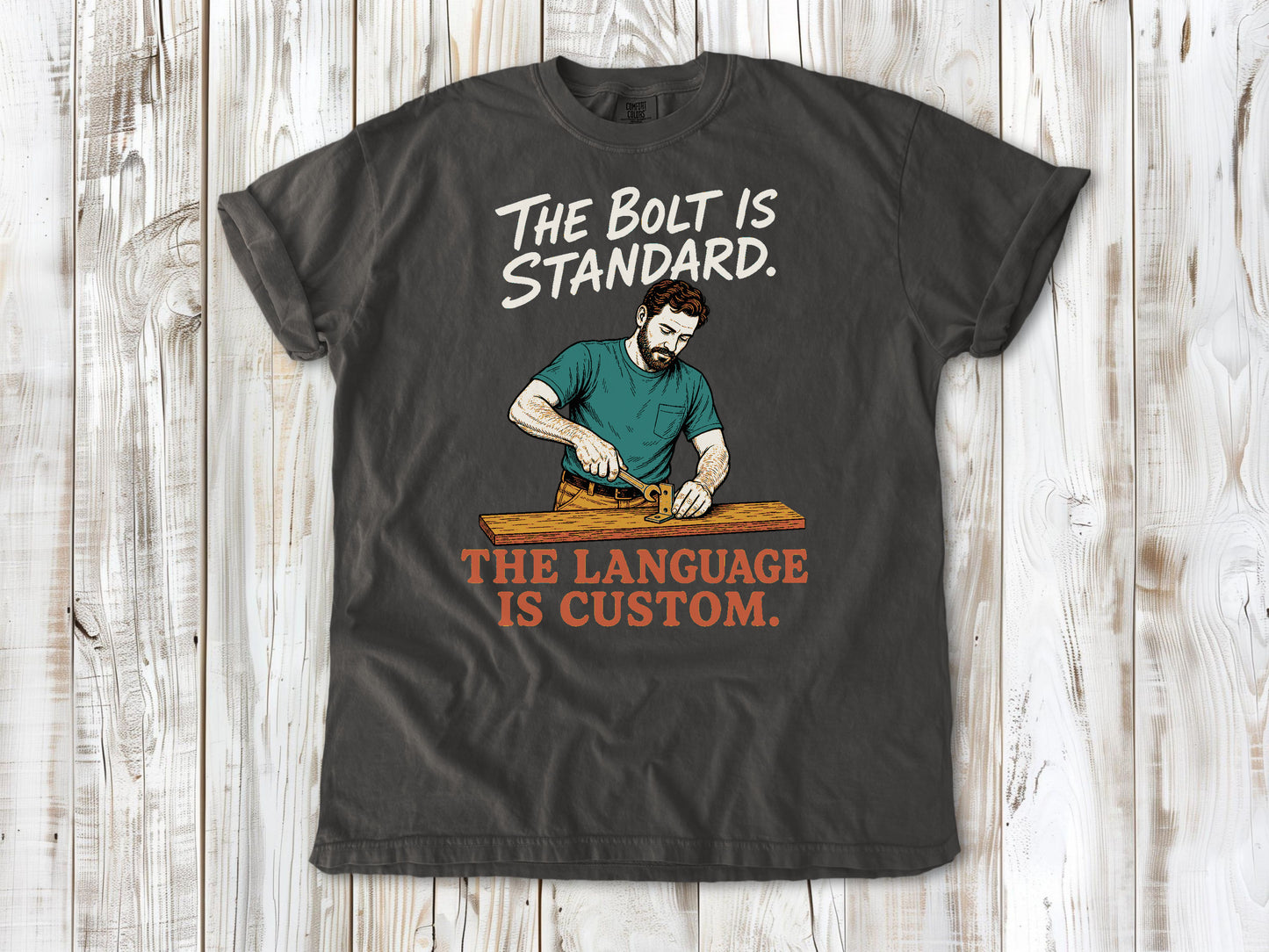 Ivory garment-dyed tee with The Bolt Is Standard The Language Is Custom mechanic graphic.