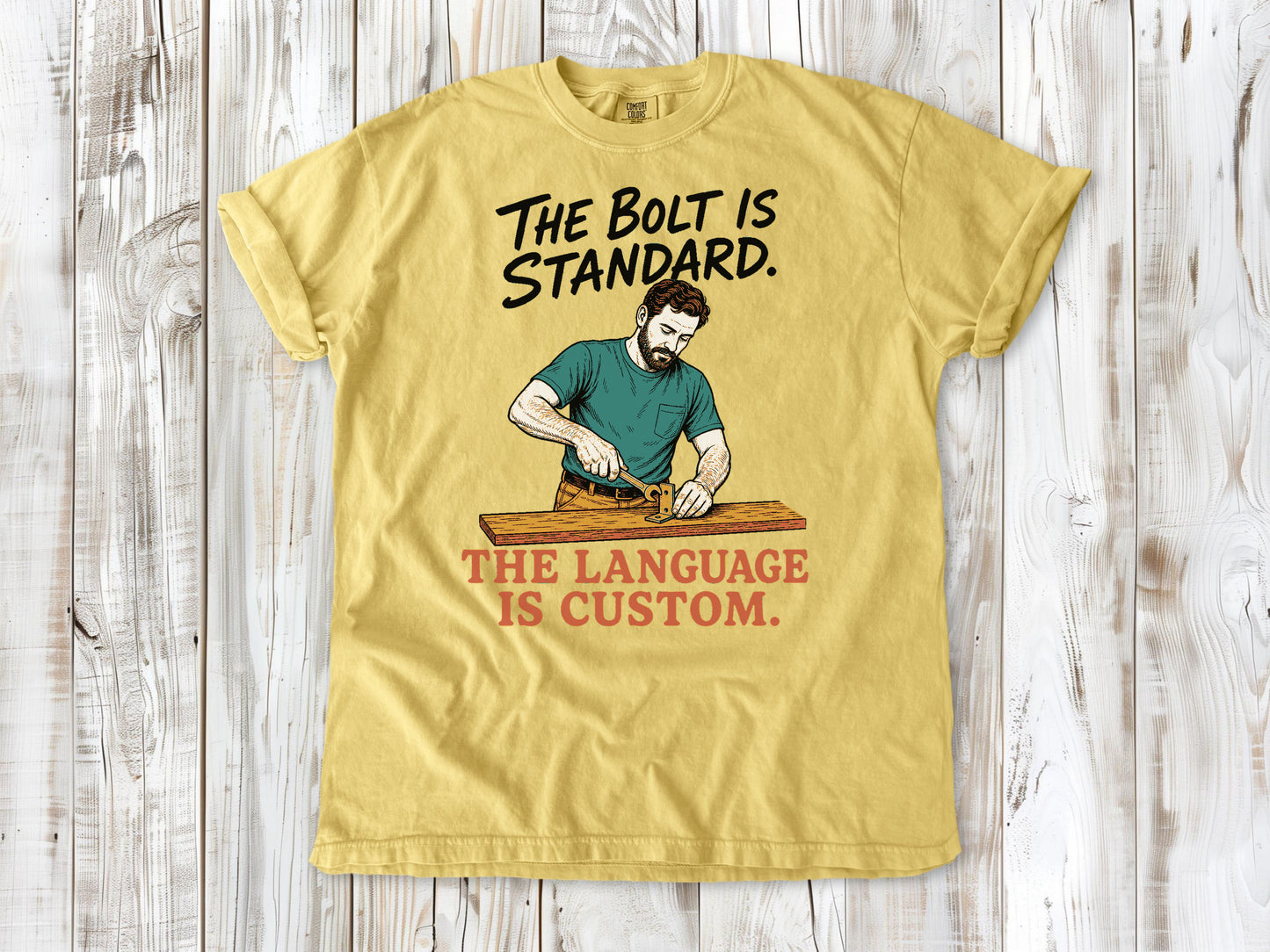 Grey garment-dyed tee with The Bolt Is Standard The Language Is Custom mechanic graphic.