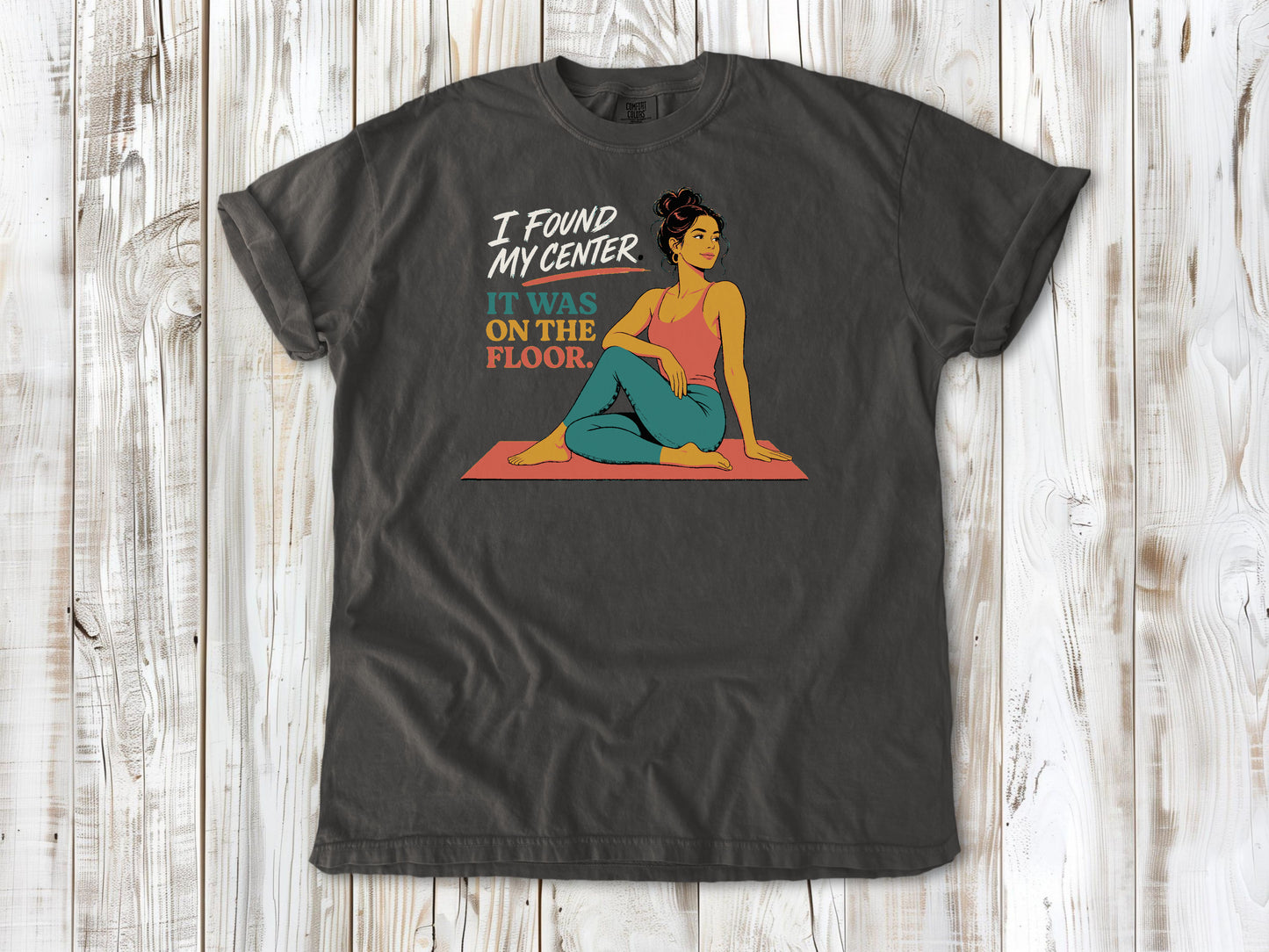 Ivory garment-dyed tee with I Found My Center It Was on the Floor yoga graphic.
