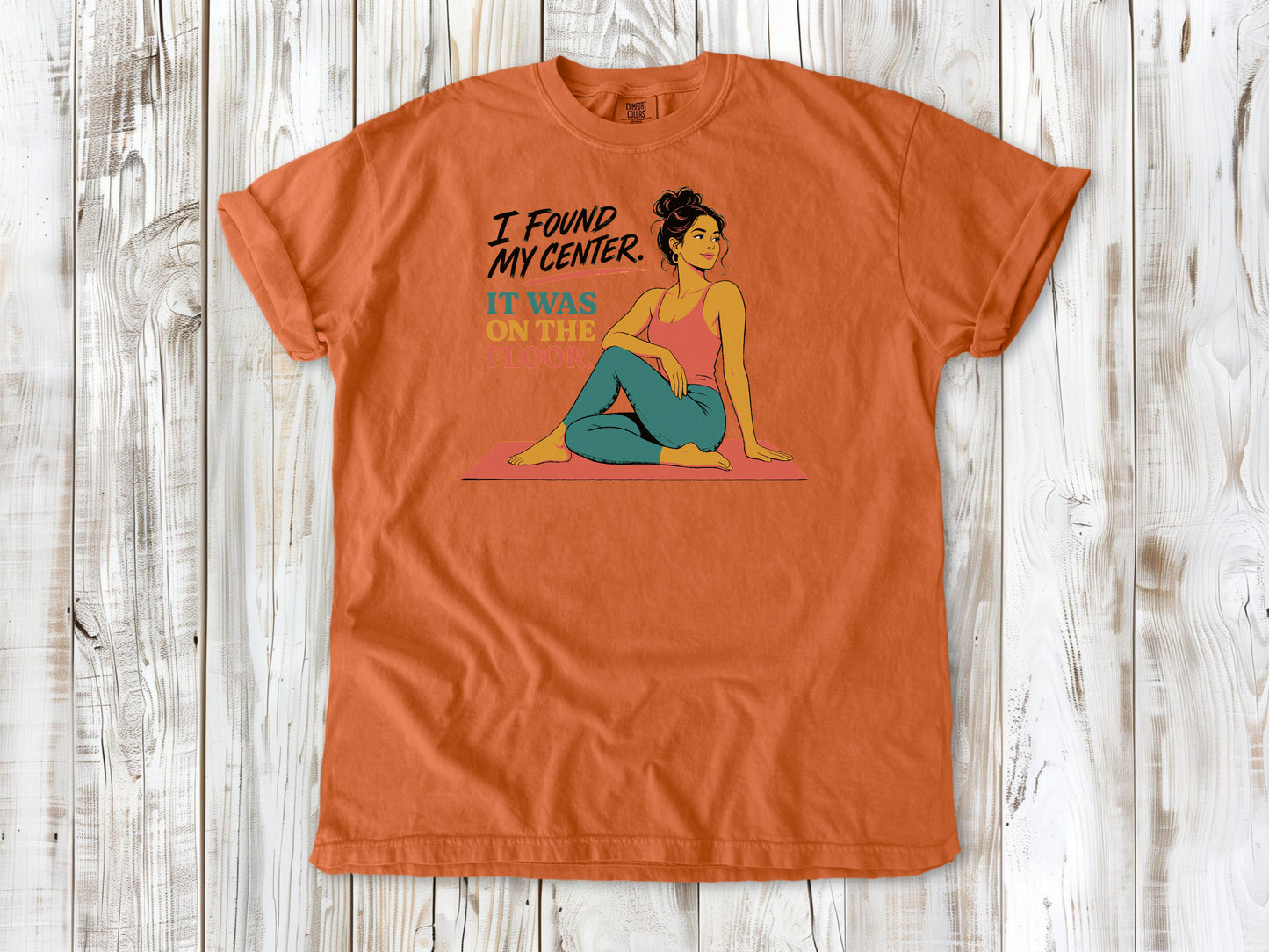 Seafoam garment-dyed tee with I Found My Center It Was on the Floor yoga graphic.