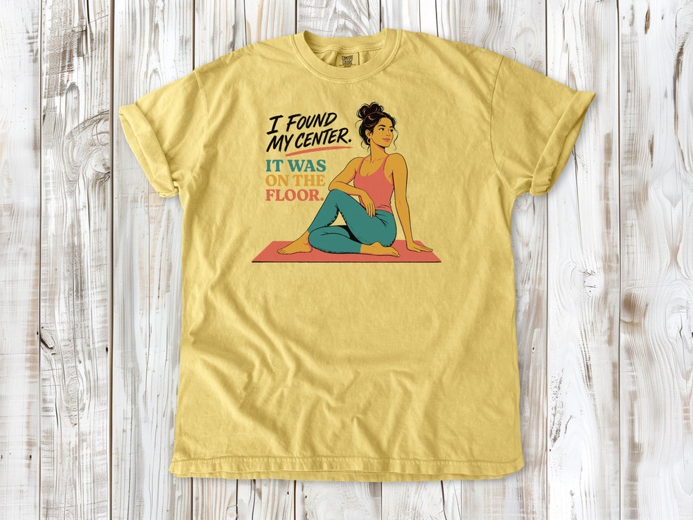 Grey garment-dyed tee with I Found My Center It Was on the Floor yoga graphic.