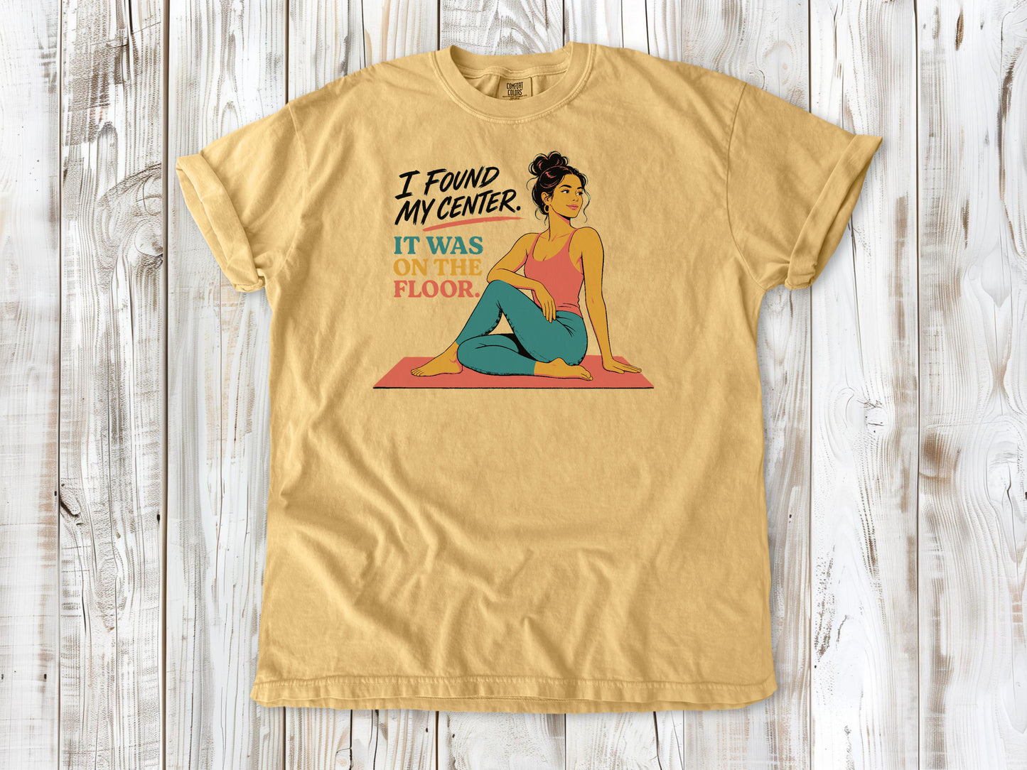 Burnt Orange garment-dyed tee with I Found My Center It Was on the Floor yoga graphic.