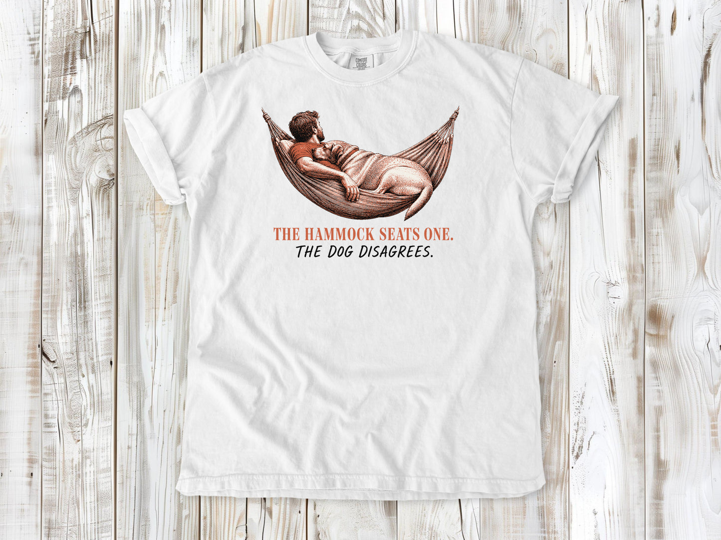 White garment-dyed tee with The Hammock Seats One The Dog Disagrees dog graphic.