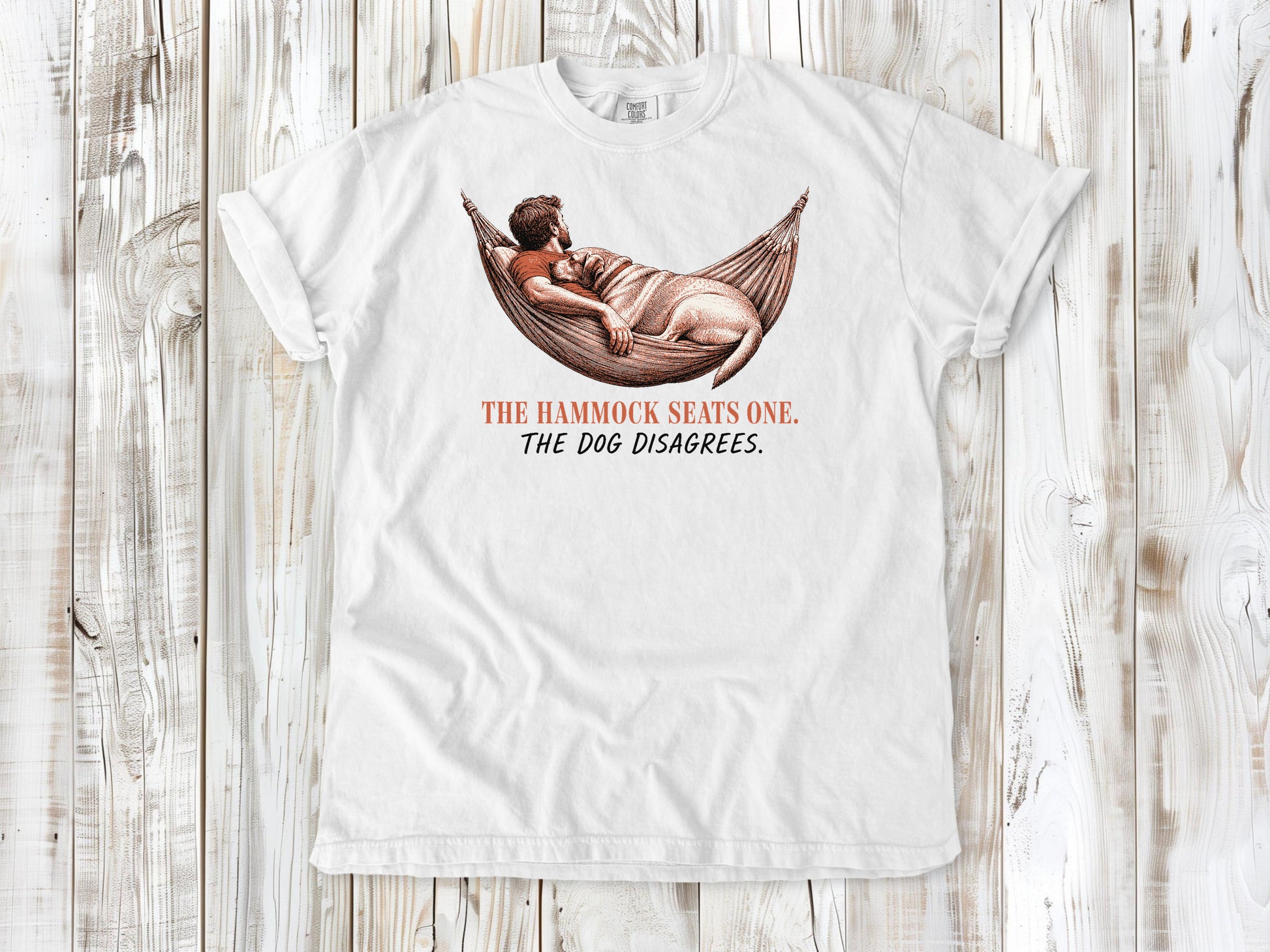 White garment-dyed tee with The Hammock Seats One The Dog Disagrees dog graphic.