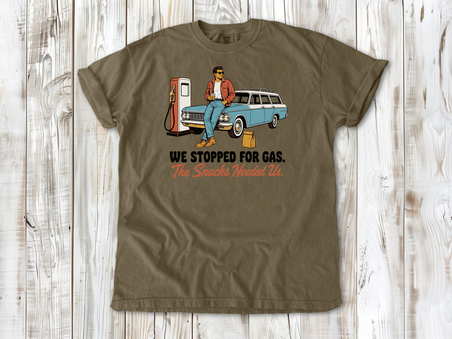 Graphite garment-dyed tee with We Stopped for Gas The Snacks Needed Us road trip graphic.