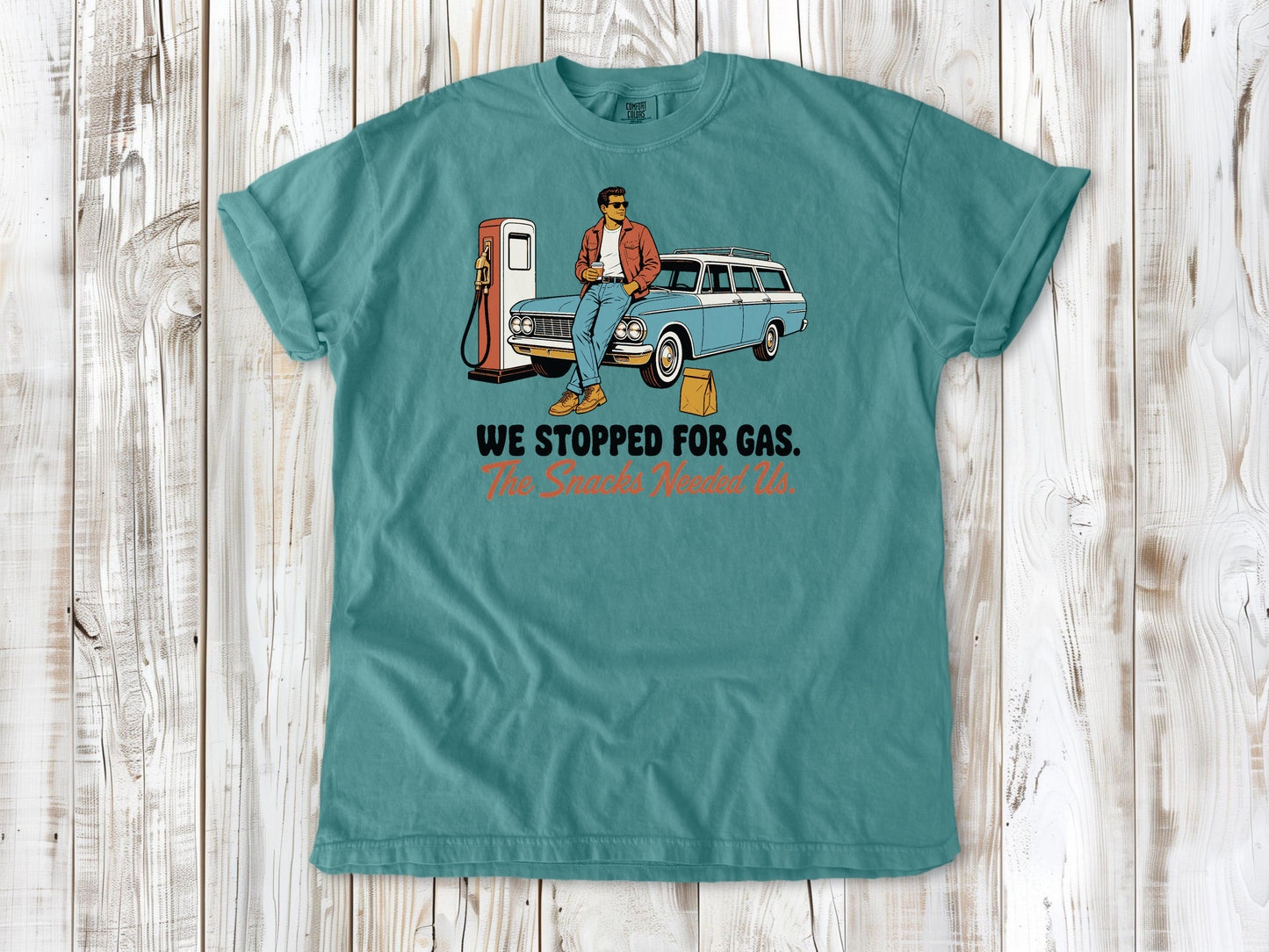 Mustard garment-dyed tee with We Stopped for Gas The Snacks Needed Us road trip graphic.