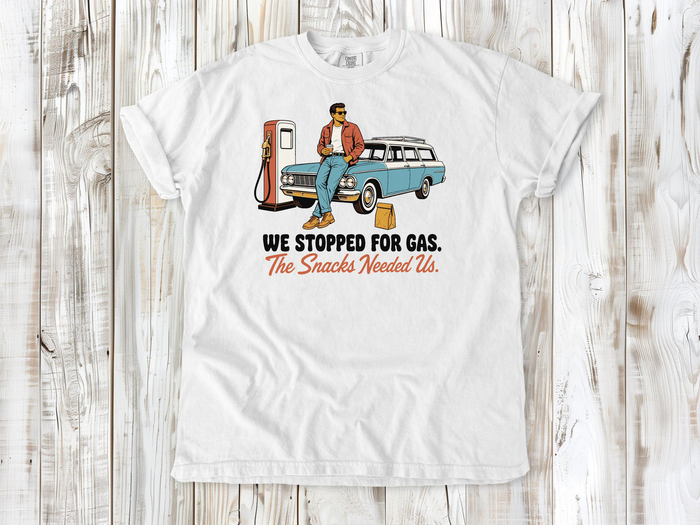 White garment-dyed tee with We Stopped for Gas The Snacks Needed Us road trip graphic.