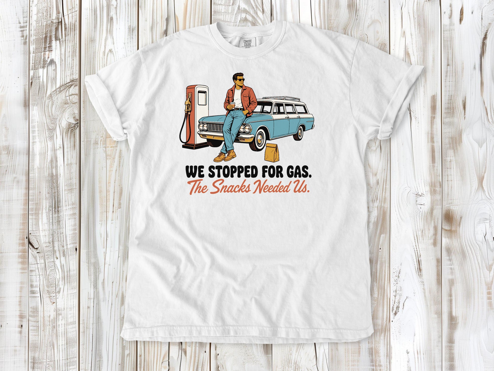 White garment-dyed tee with We Stopped for Gas The Snacks Needed Us road trip graphic.