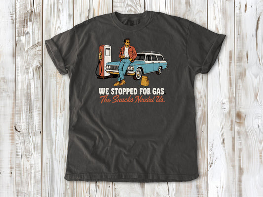 Ivory garment-dyed tee with We Stopped for Gas The Snacks Needed Us road trip graphic.