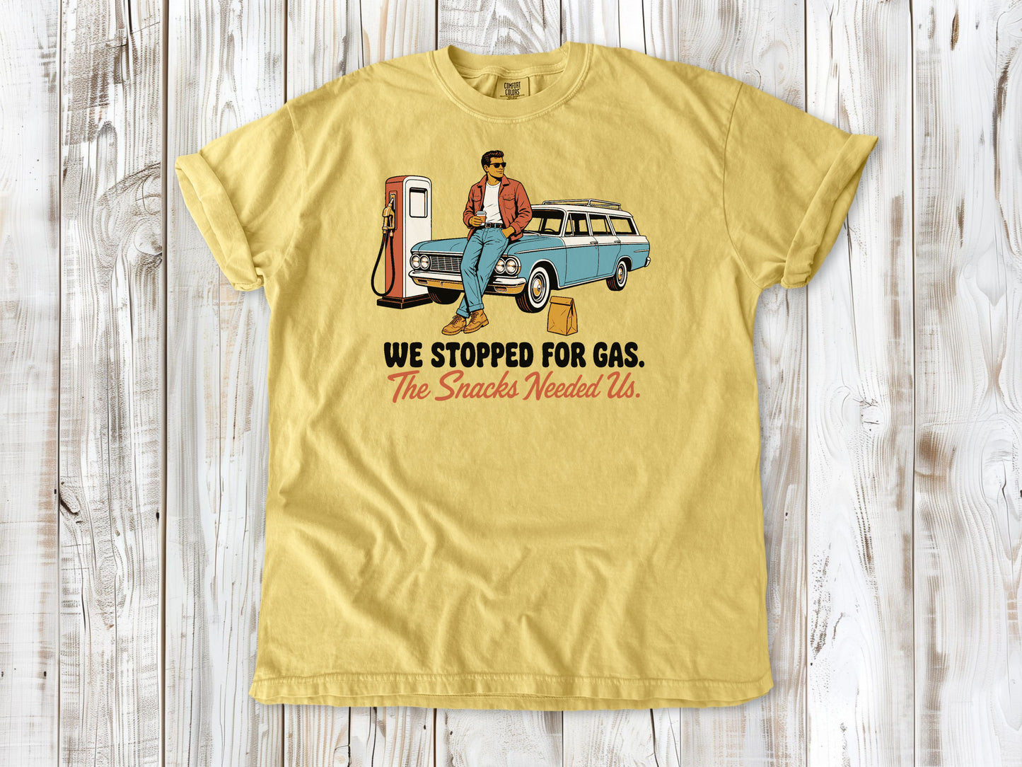 Grey garment-dyed tee with We Stopped for Gas The Snacks Needed Us road trip graphic.