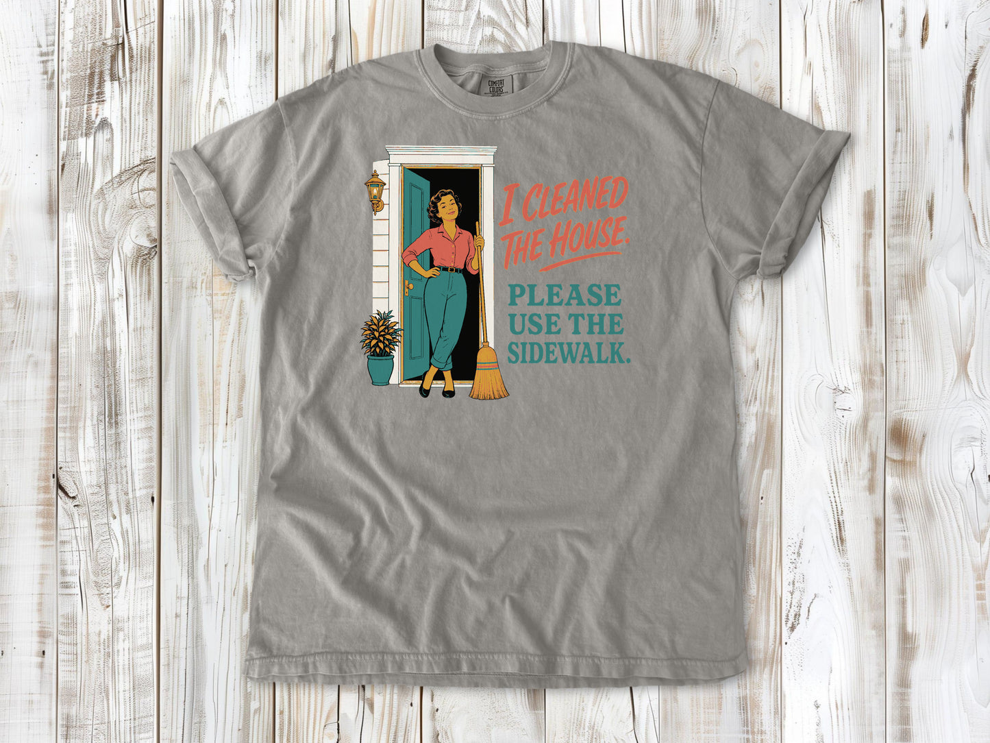 Khaki garment-dyed tee with I Cleaned the House Please Use the Sidewalk cleaning graphic.