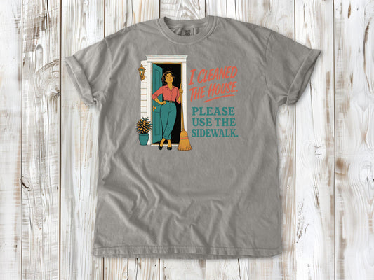 Khaki garment-dyed tee with I Cleaned the House Please Use the Sidewalk cleaning graphic.