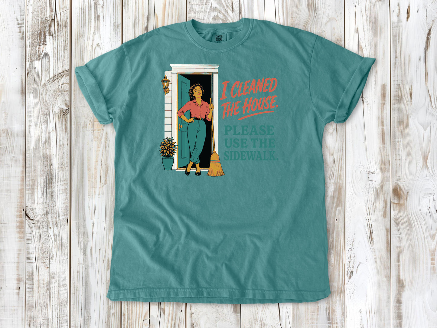 Mustard garment-dyed tee with I Cleaned the House Please Use the Sidewalk cleaning graphic.