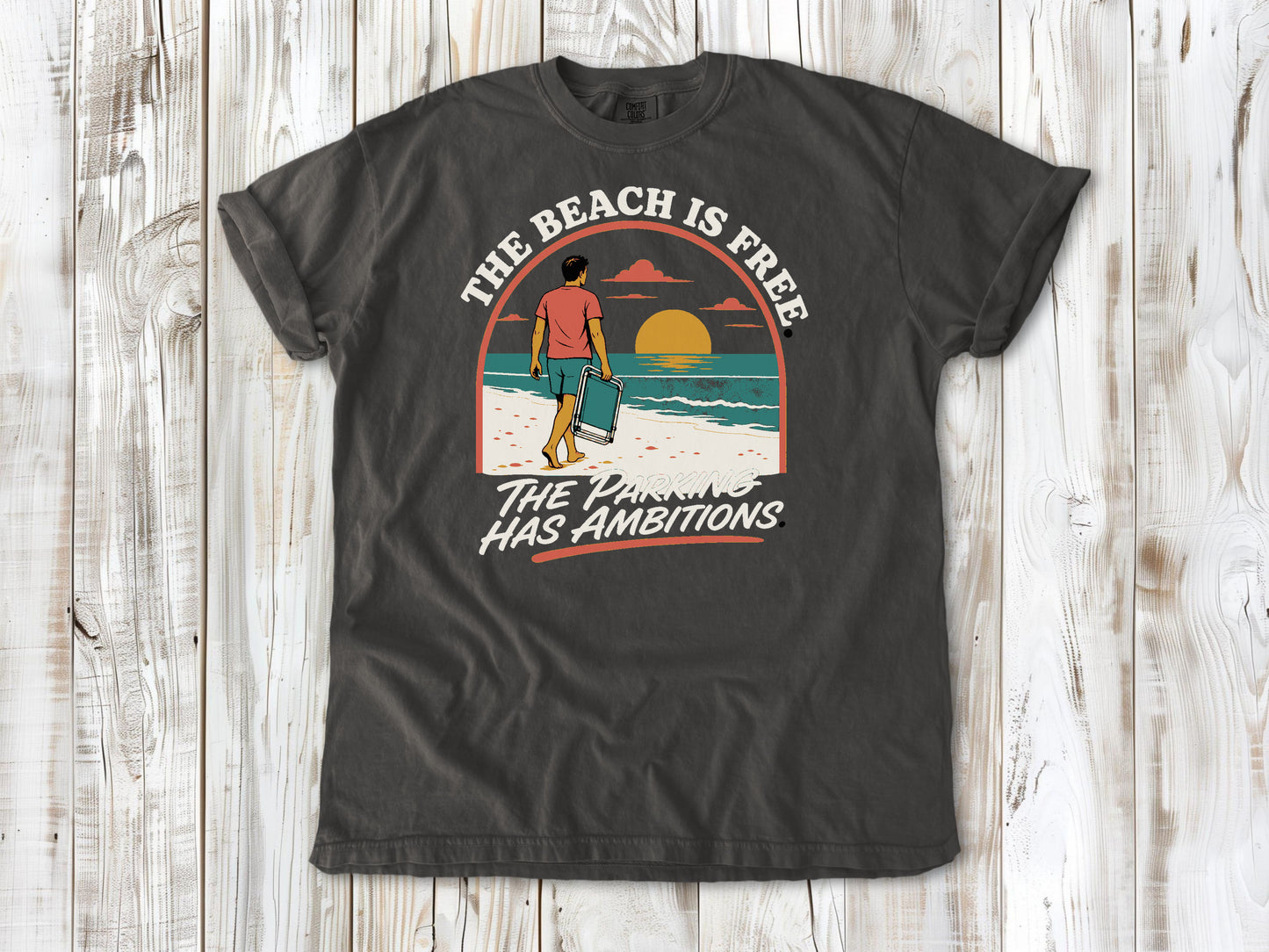 Ivory garment-dyed tee with The Beach Is Free The Parking Has Ambitions coastal graphic.