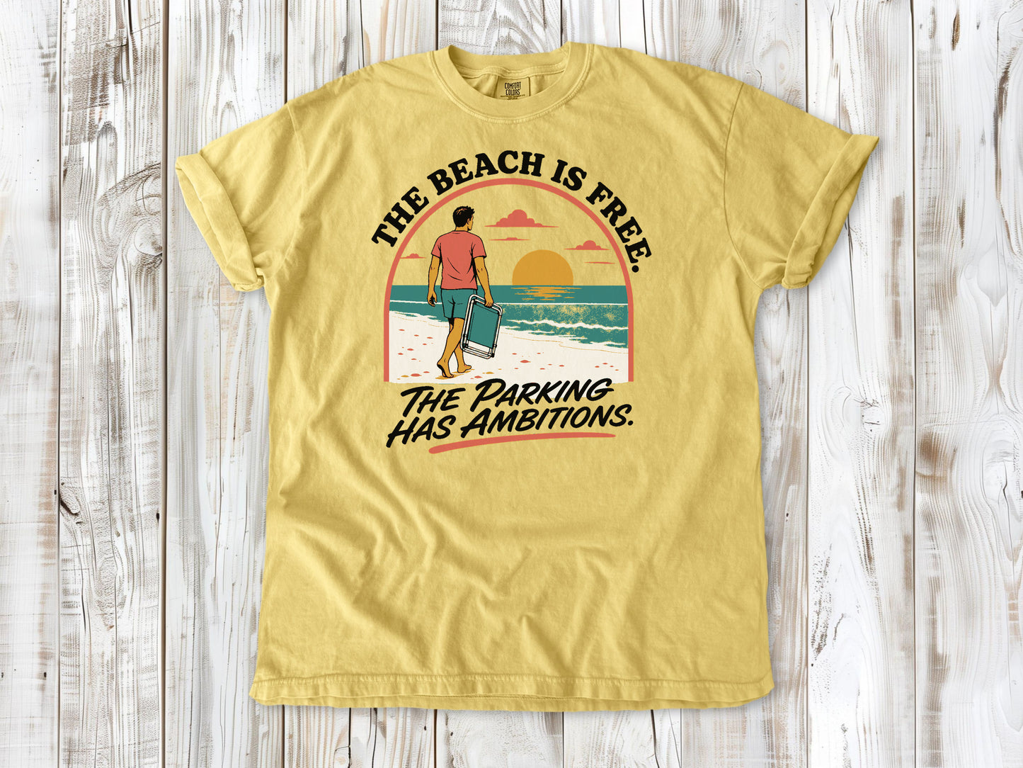Grey garment-dyed tee with The Beach Is Free The Parking Has Ambitions coastal graphic.