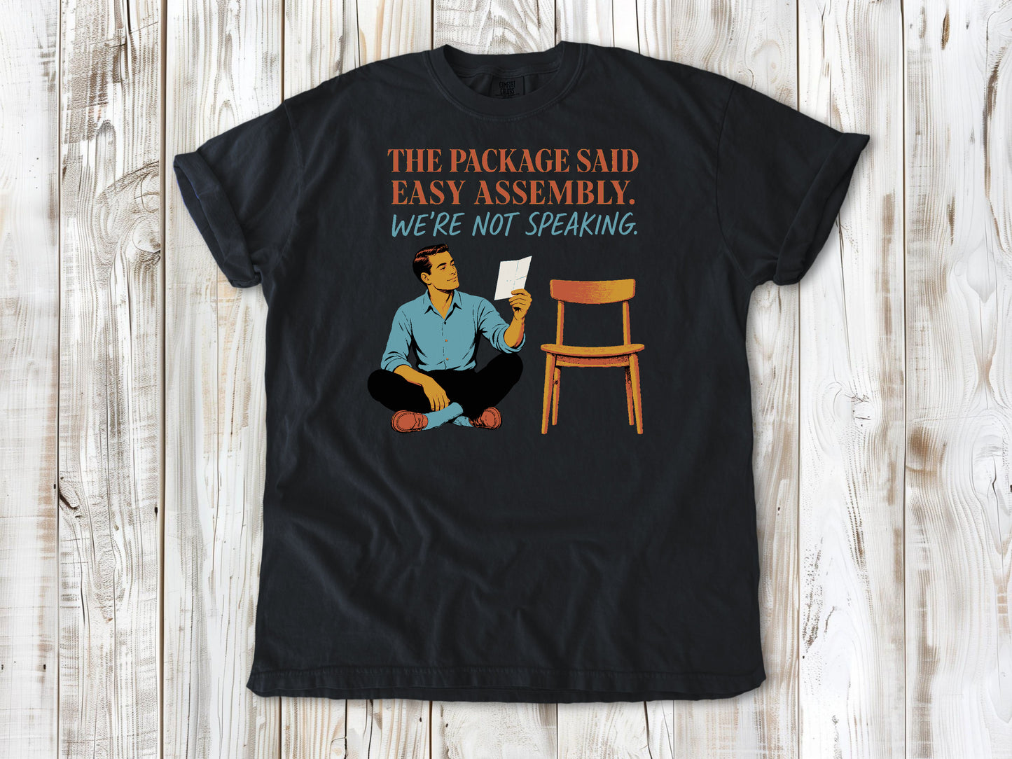 Washed Denim garment-dyed tee with The Package Said Easy Assembly We're Not Speaking DIY graphic.