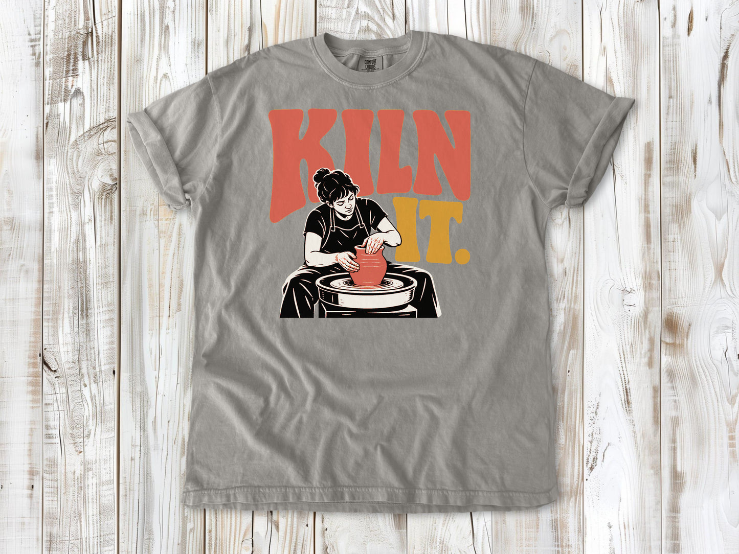 Khaki garment-dyed tee with Kiln It pottery graphic.