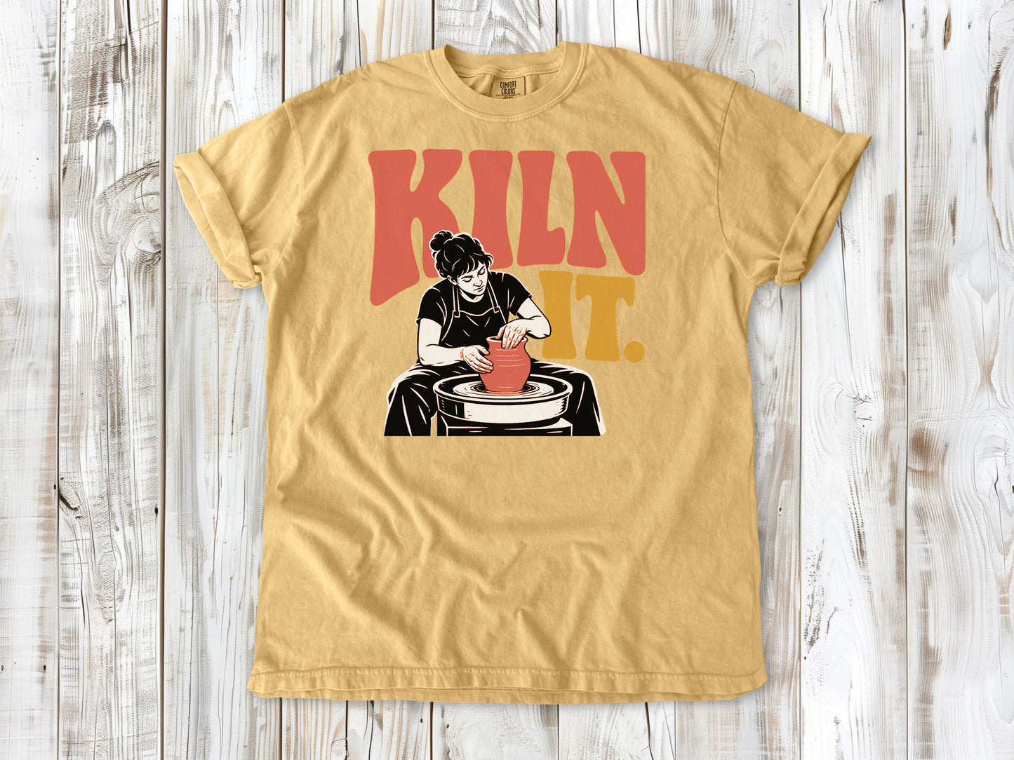Burnt Orange garment-dyed tee with Kiln It pottery graphic.