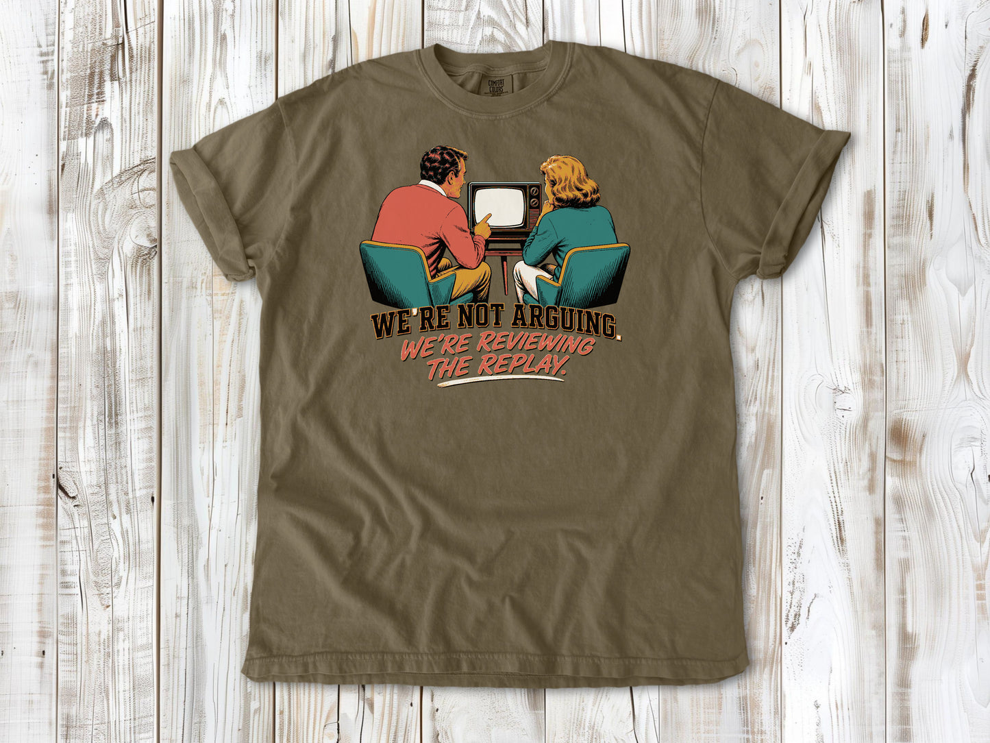 Graphite garment-dyed tee with We're Not Arguing We're Reviewing the Replay game day graphic.