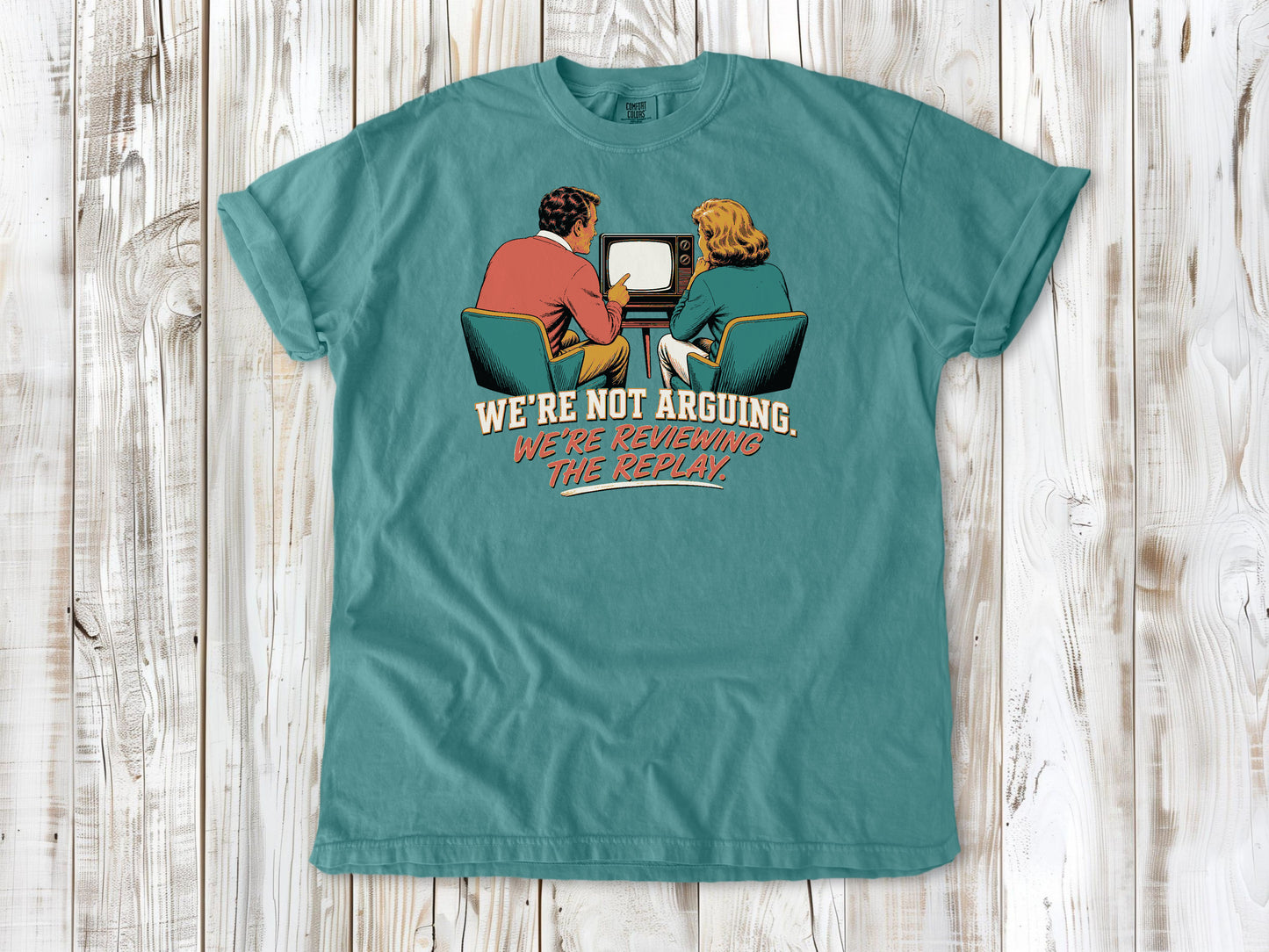Mustard garment-dyed tee with We're Not Arguing We're Reviewing the Replay game day graphic.