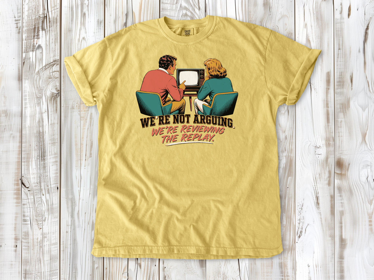 Grey garment-dyed tee with We're Not Arguing We're Reviewing the Replay game day graphic.