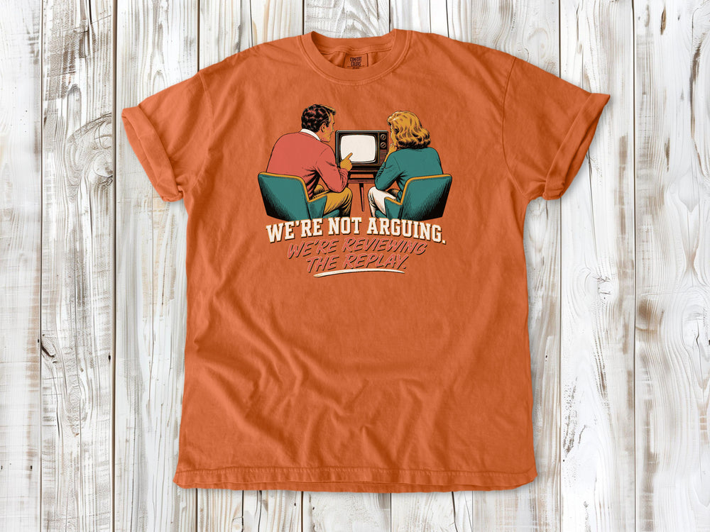 Seafoam garment-dyed tee with We're Not Arguing We're Reviewing the Replay game day graphic.