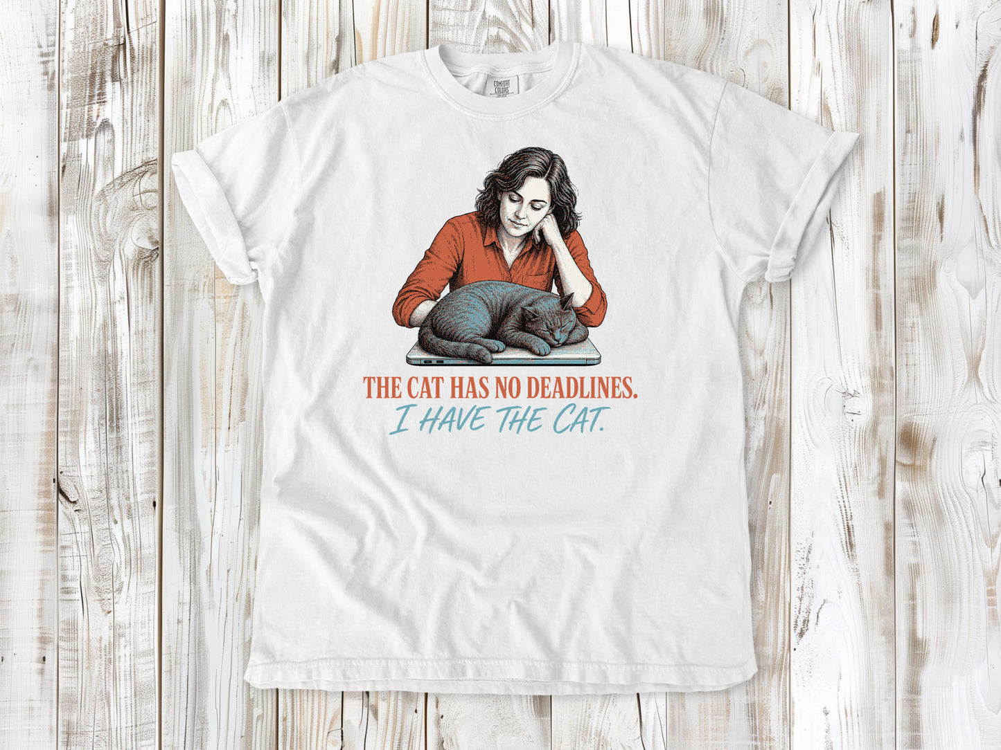 White garment-dyed tee with The Cat Has No Deadlines I Have the Cat remote work graphic.