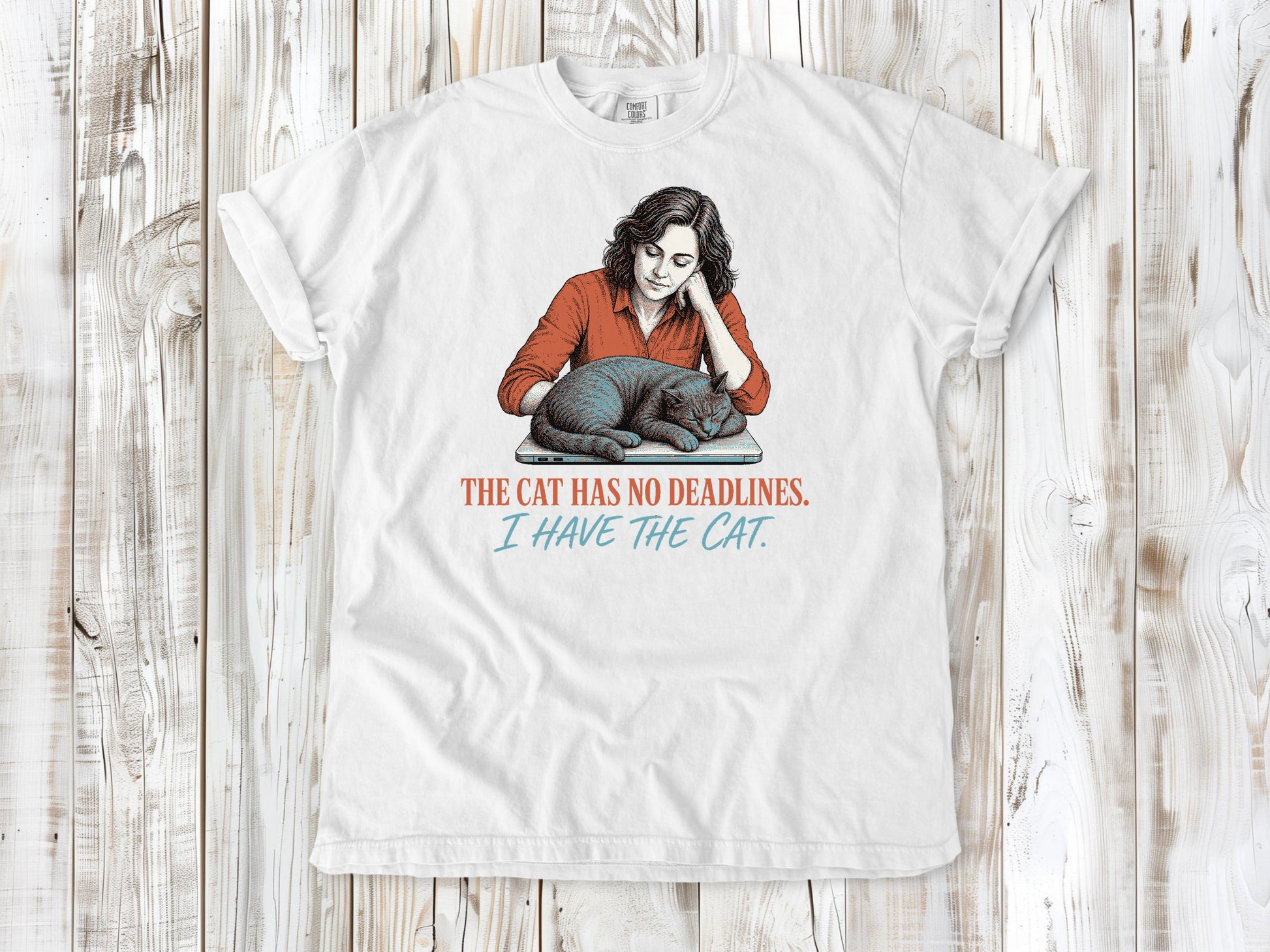 White garment-dyed tee with The Cat Has No Deadlines I Have the Cat remote work graphic.