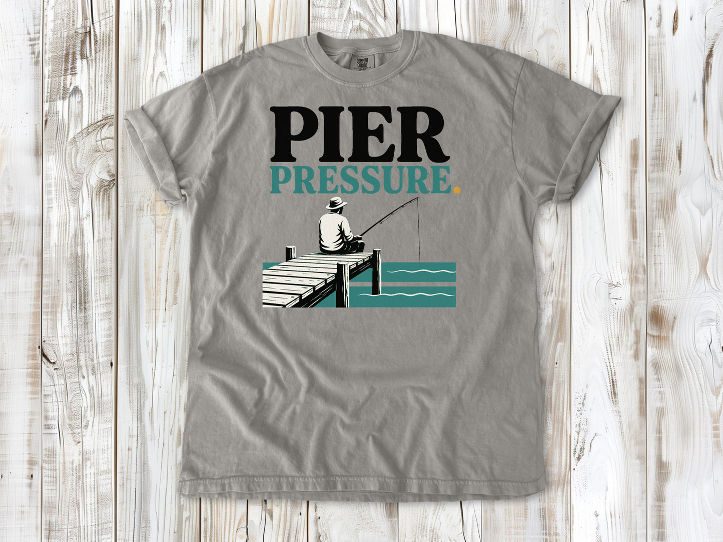 Khaki garment-dyed tee with Pier Pressure fishing graphic.