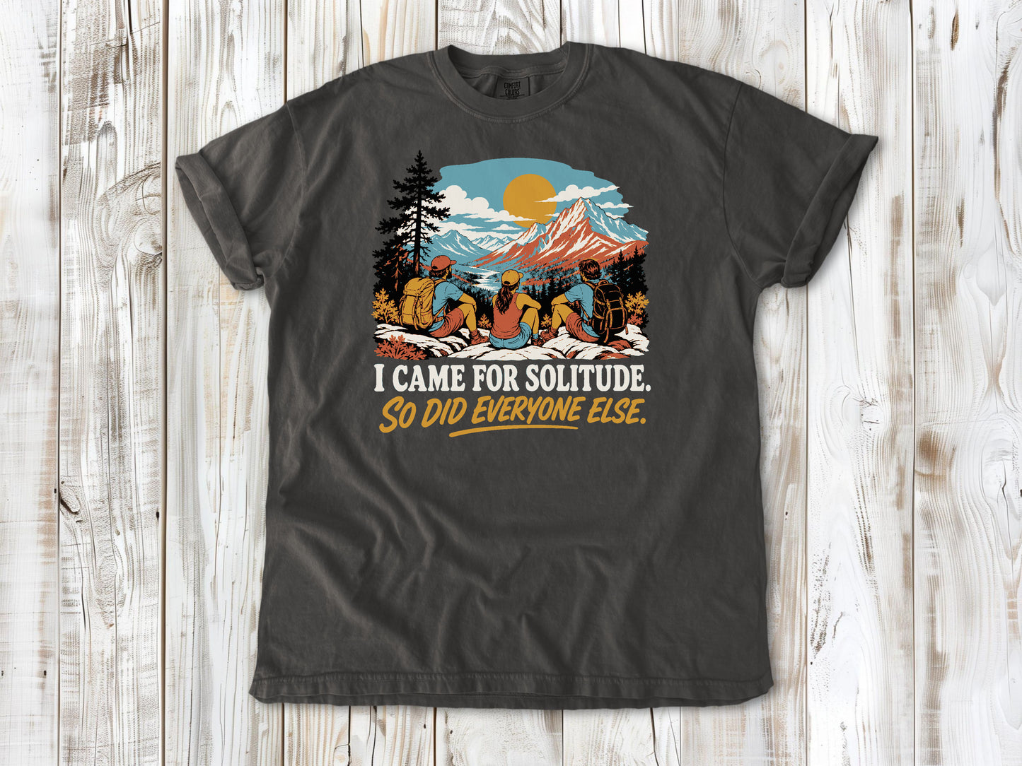 Ivory garment-dyed tee with I Came for Solitude So Did Everyone Else hiking graphic.