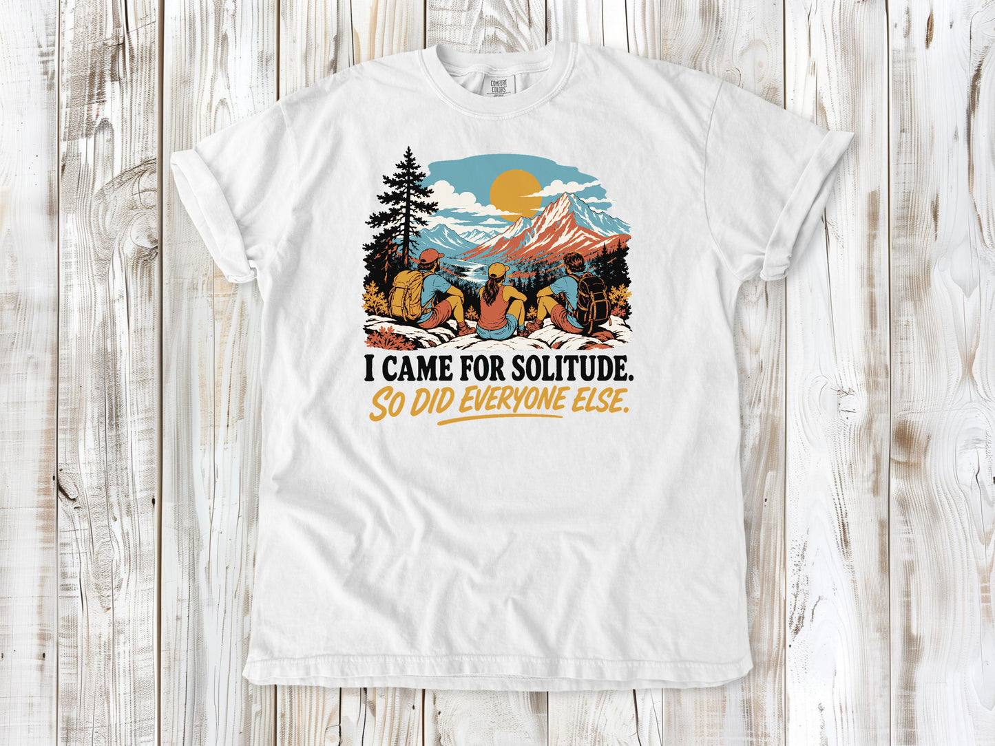 White garment-dyed tee with I Came for Solitude So Did Everyone Else hiking graphic.
