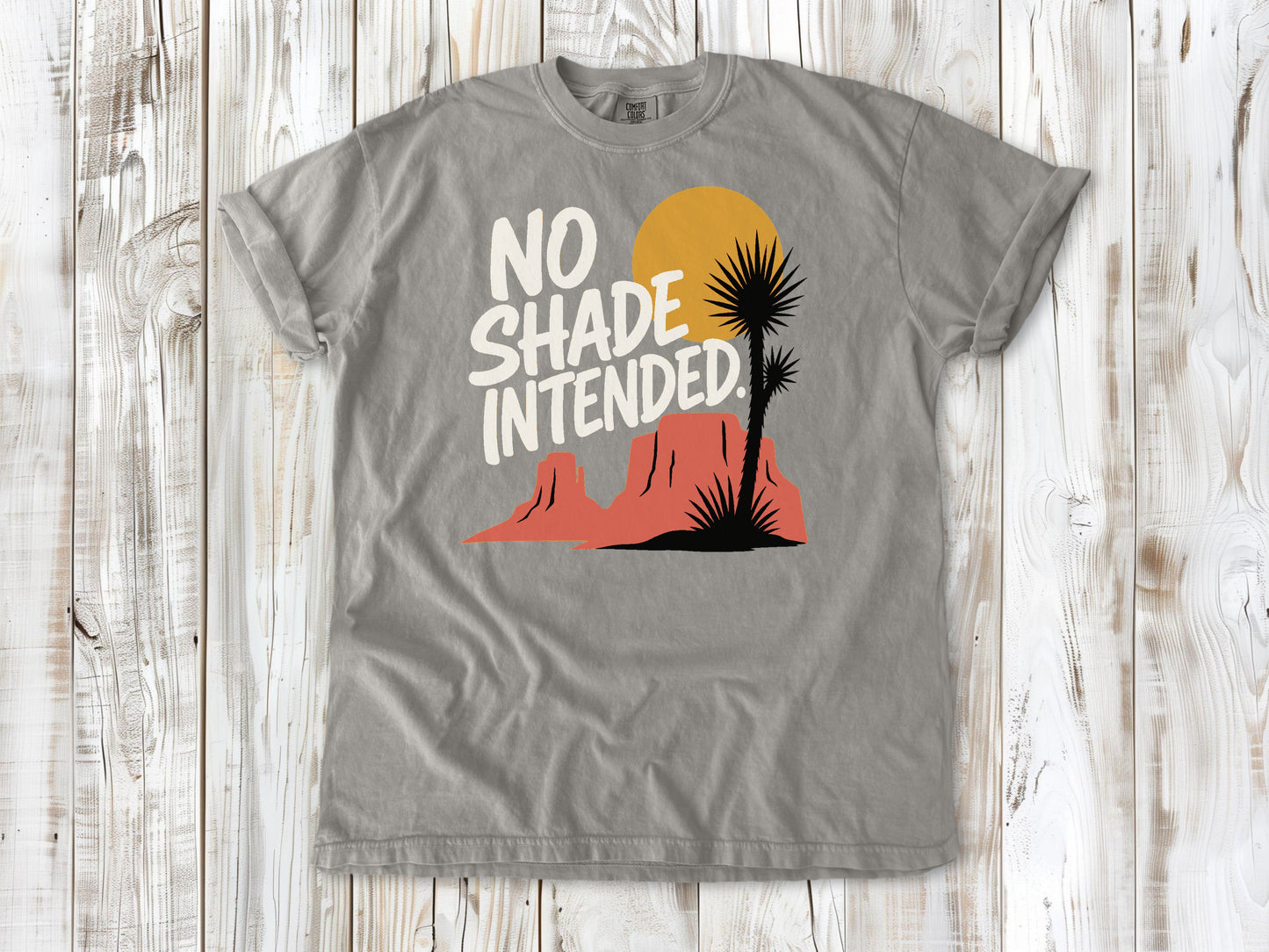 Khaki garment-dyed tee with No Shade Intended desert hiking graphic.