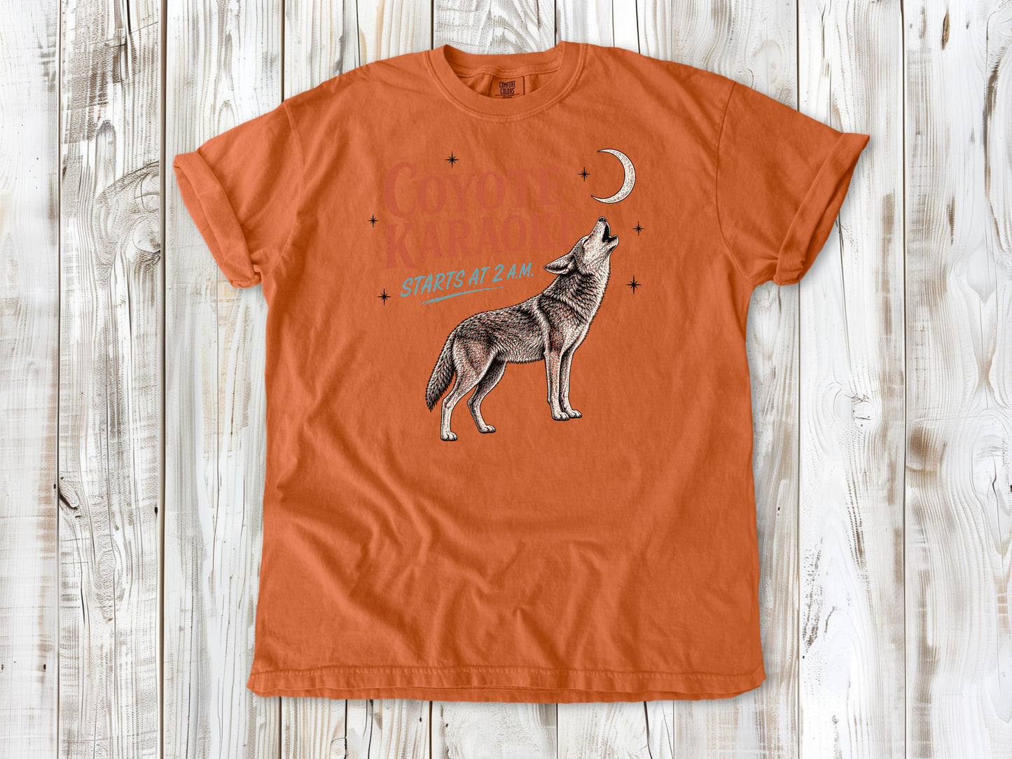 Seafoam garment-dyed tee with Coyote Karaoke Starts at 2 AM camping graphic.