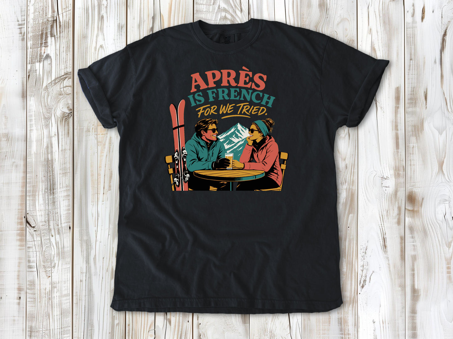 Washed Denim garment-dyed tee with Après Is French for We Tried skiing graphic.