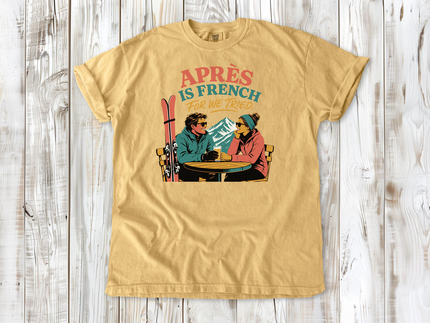 Burnt Orange garment-dyed tee with Après Is French for We Tried skiing graphic.