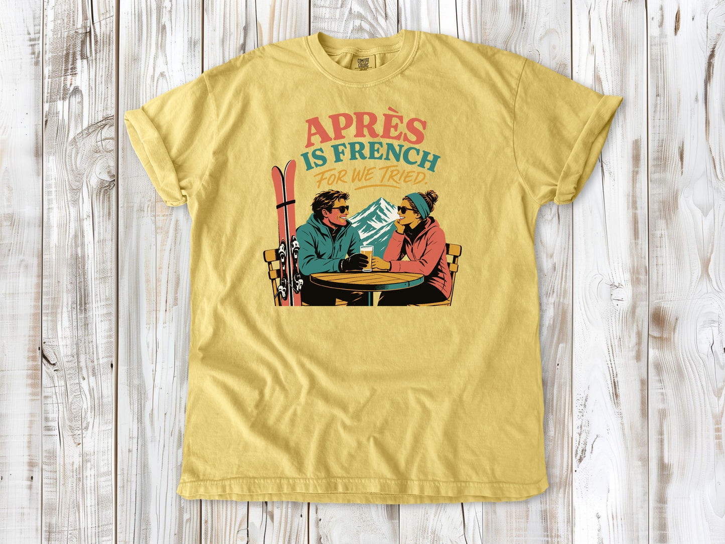 Grey garment-dyed tee with Après Is French for We Tried skiing graphic.