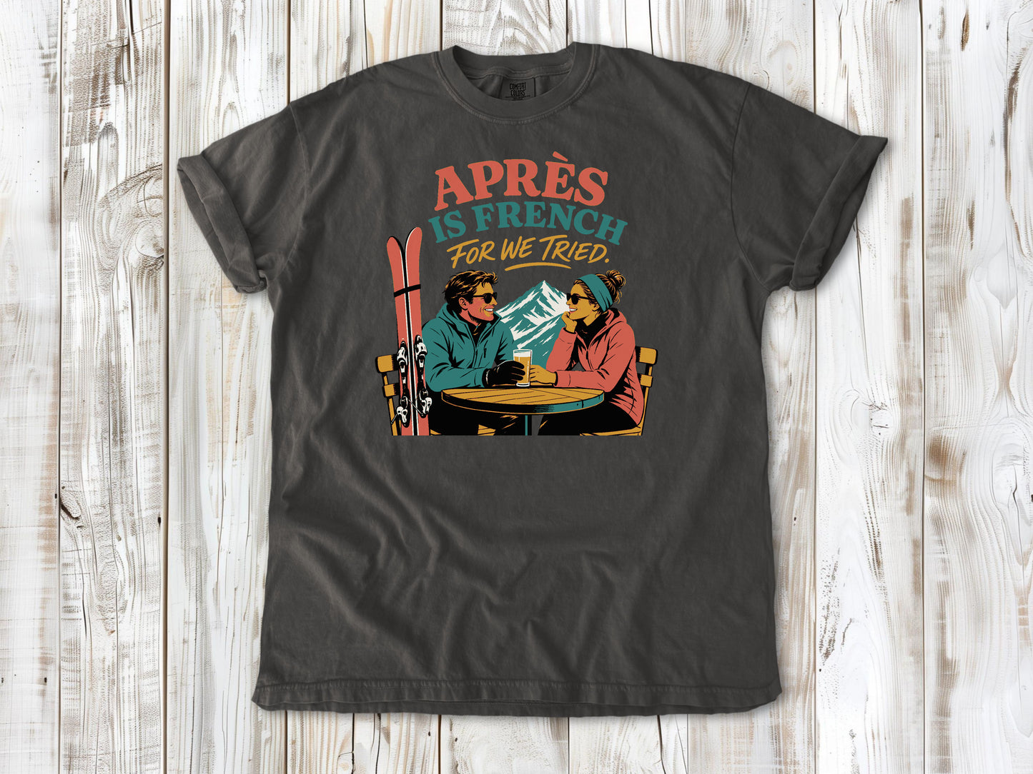 Ivory garment-dyed tee with Après Is French for We Tried skiing graphic.