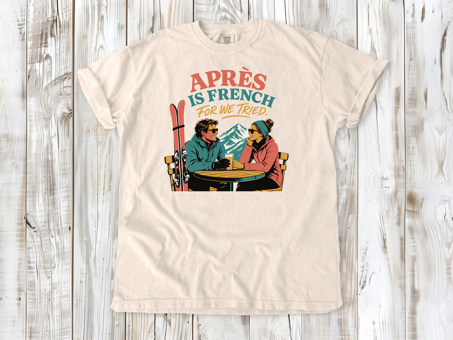 Butter garment-dyed tee with Après Is French for We Tried skiing graphic.